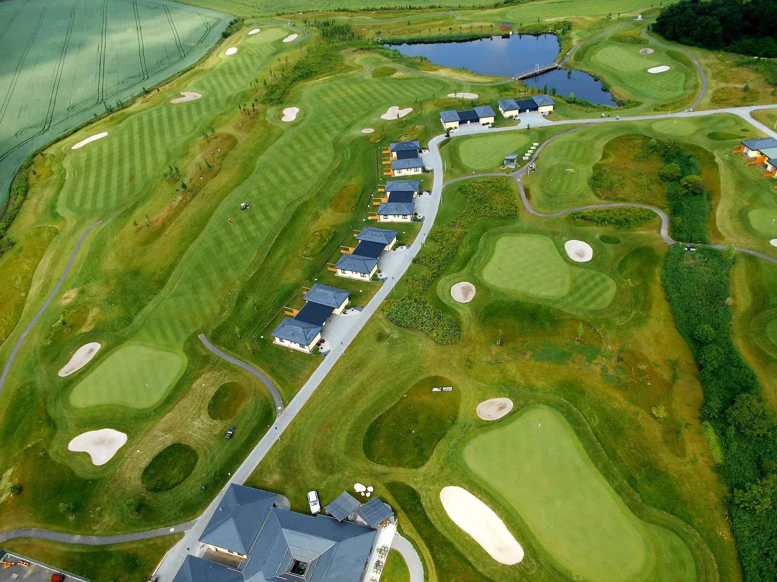 Aerial view of Golf Resort Black Bridge, with apartments lining the fairways on its flat, open site