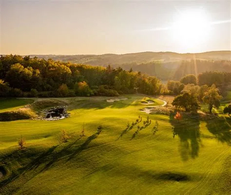 Sunlit fairway and rolling wooded hills at Panorama Golf Resort, Kácov